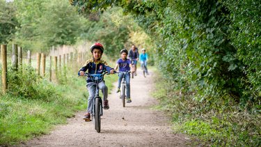 A family cycling through the Greenway