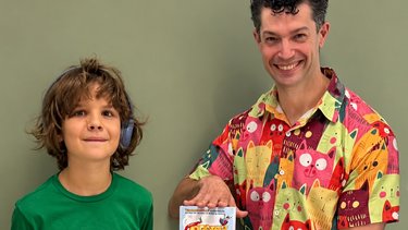 Chip Colquhoun and Noah Shaw stand together with a copy of The Bestest Story In The World... Ever!