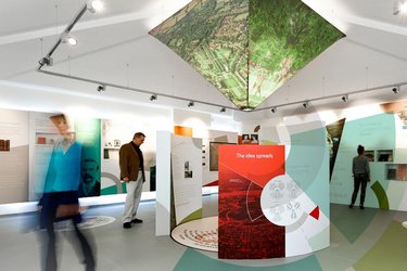 People stand in the exhibition space, reading from information panels.